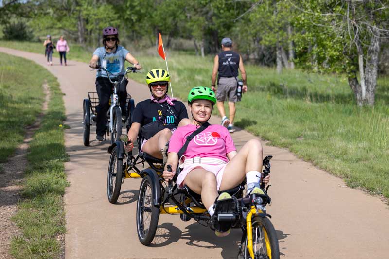 patients in their adjusted bicycles enjoying a ride through the park