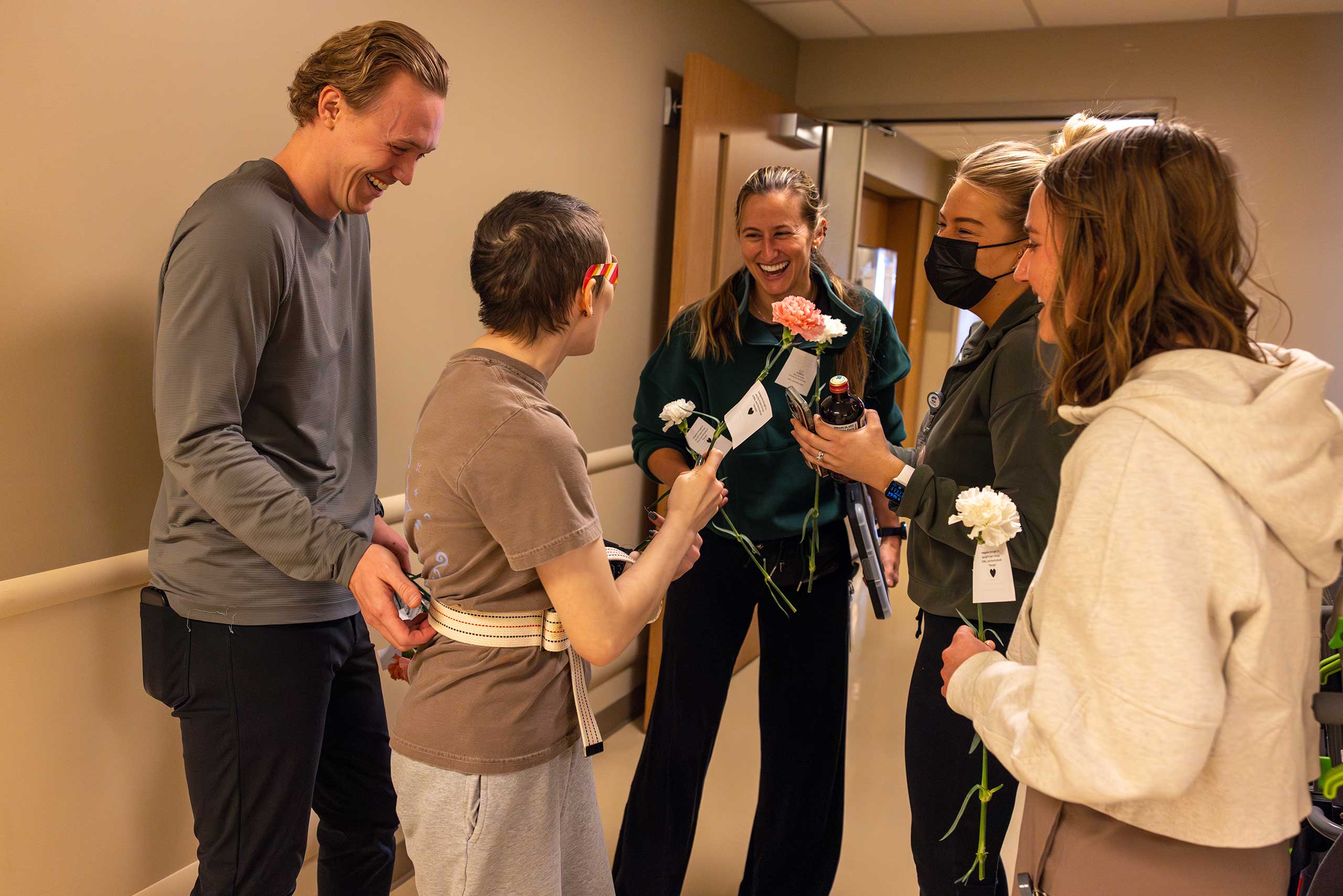 patient giving the staff workers flowers to show a gratitude