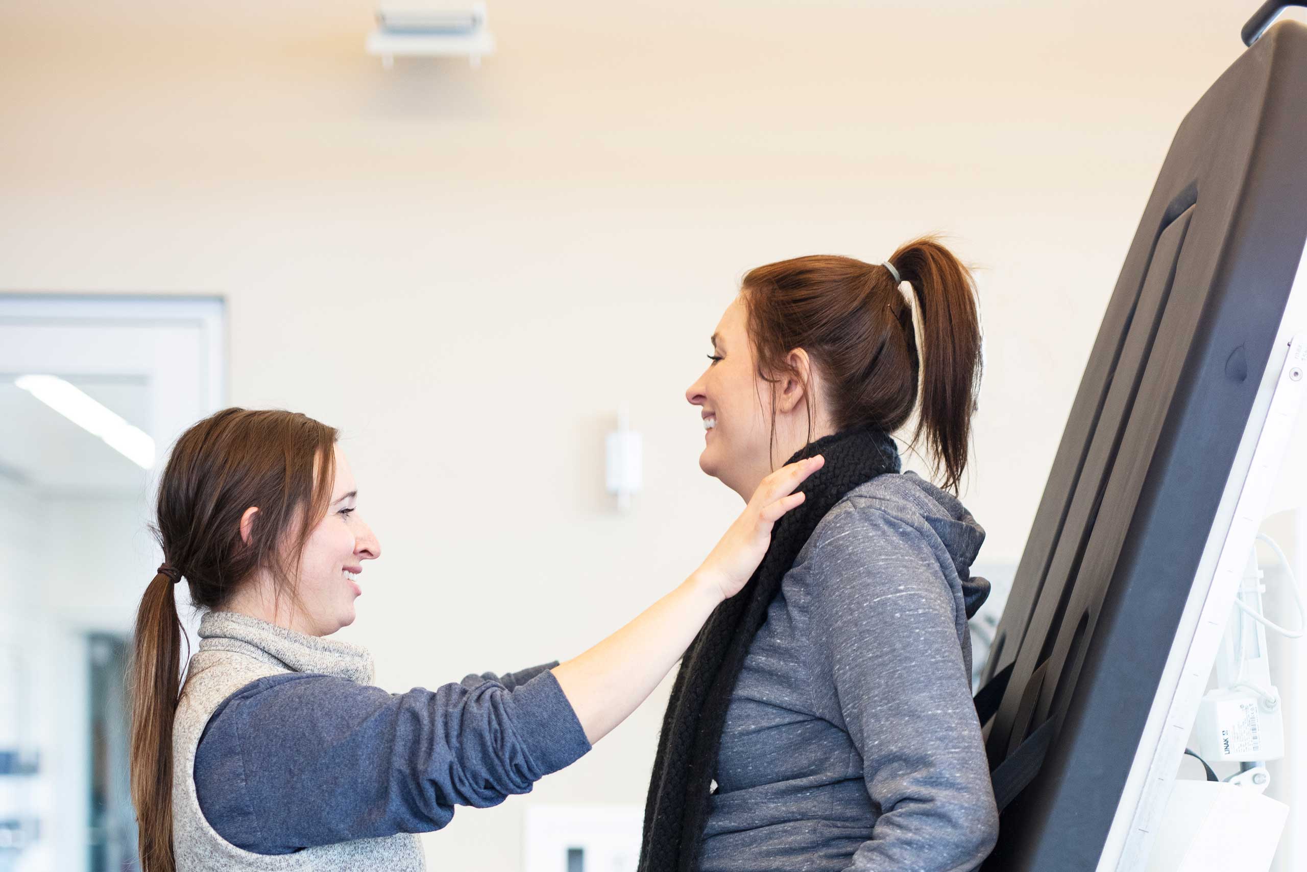 Patient with a physical therapist assisting with excercises